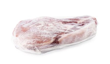 Photo of One frozen pork steak in plastic wrap isolated on white