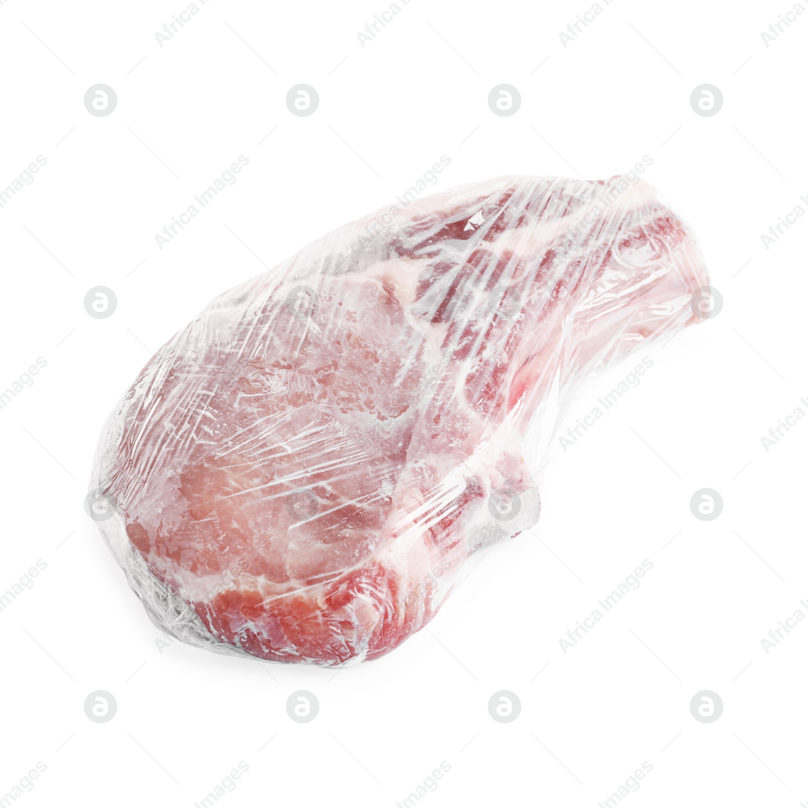 Photo of One frozen pork steak in plastic wrap isolated on white