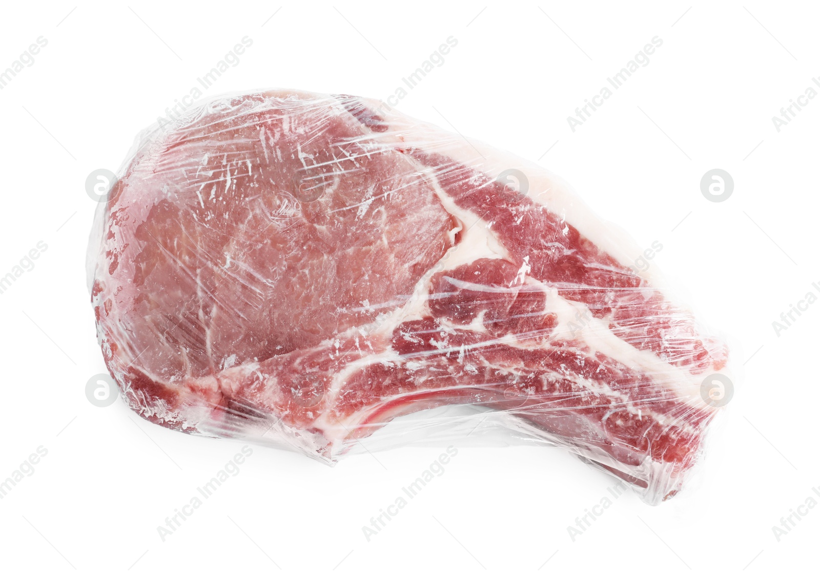 Photo of One frozen pork steak in plastic wrap isolated on white