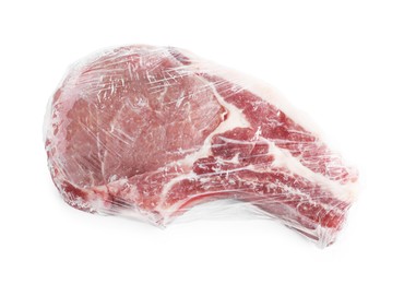 Photo of One frozen pork steak in plastic wrap isolated on white