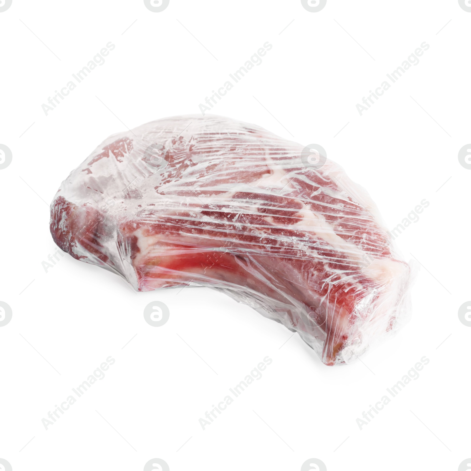 Photo of One frozen pork steak in plastic wrap isolated on white