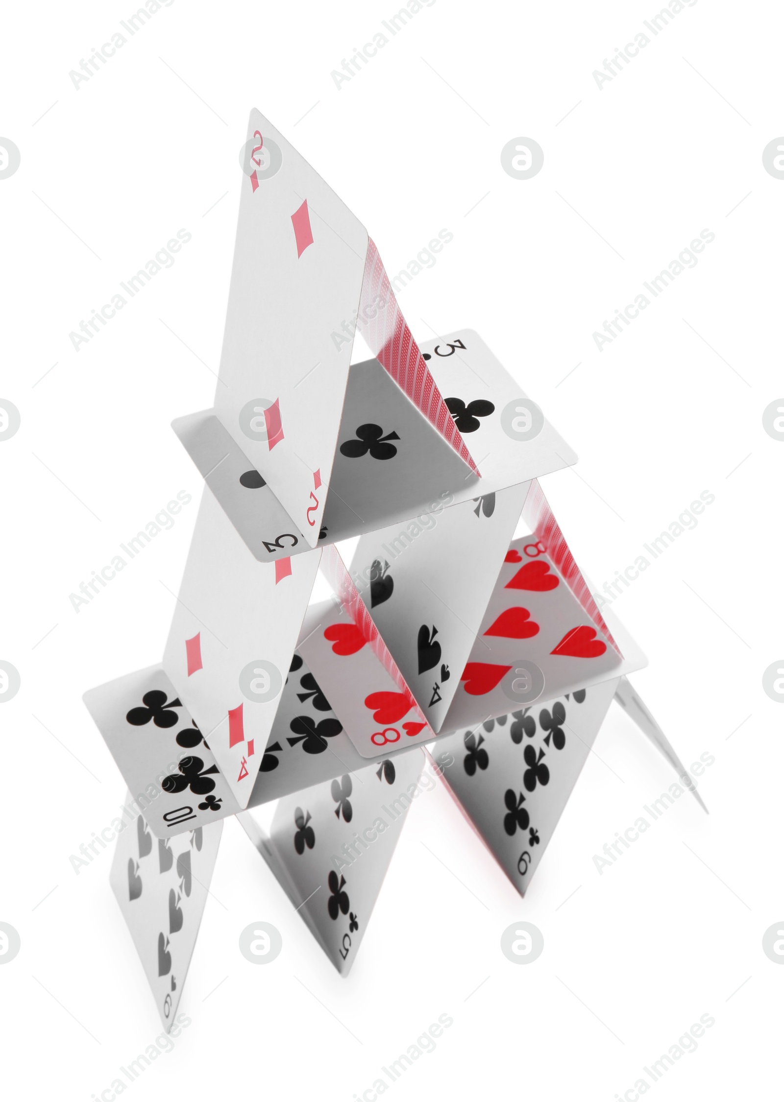 Photo of House of playing cards isolated on white