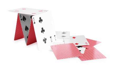 Photo of Collapsed house of playing cards isolated on white