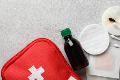 Photo of Topical iodine and other first aid kit components on light background, flat lay. Space for text