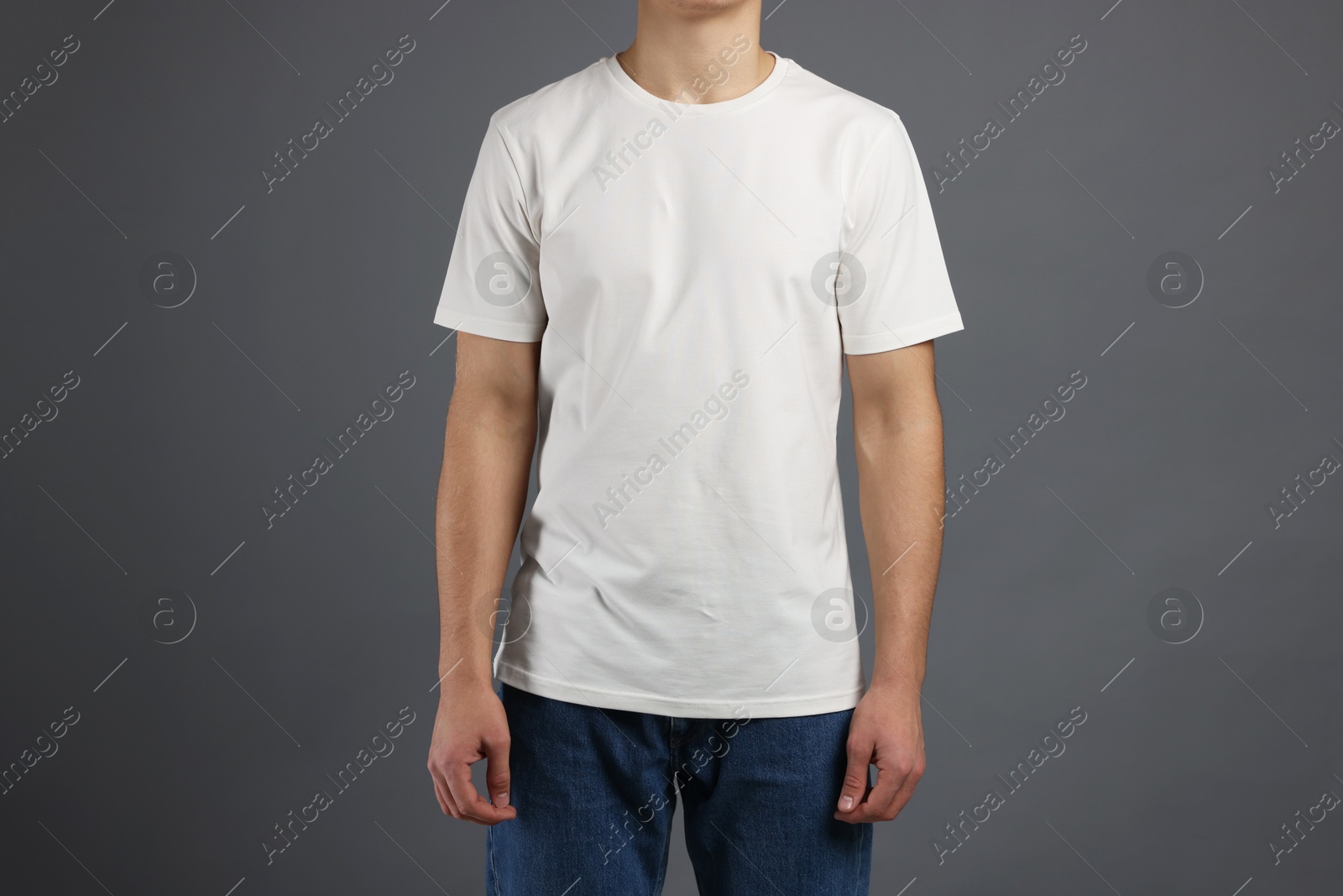 Photo of Man in stylish t-shirt on grey background, closeup. Mockup for design