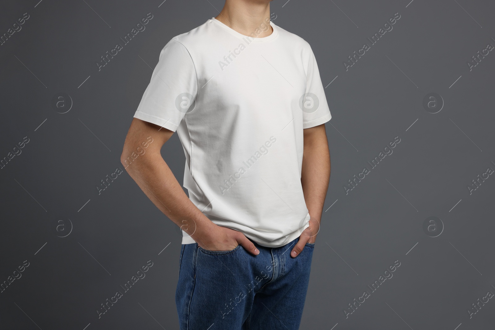 Photo of Man in stylish t-shirt on grey background, closeup. Mockup for design