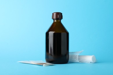 Photo of Topical iodine and bandages on light blue background