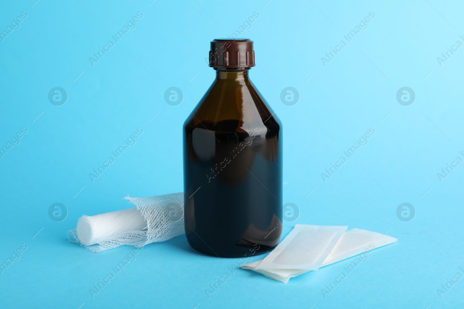 Photo of Topical iodine and bandages on light blue background