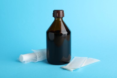 Photo of Topical iodine and bandages on light blue background