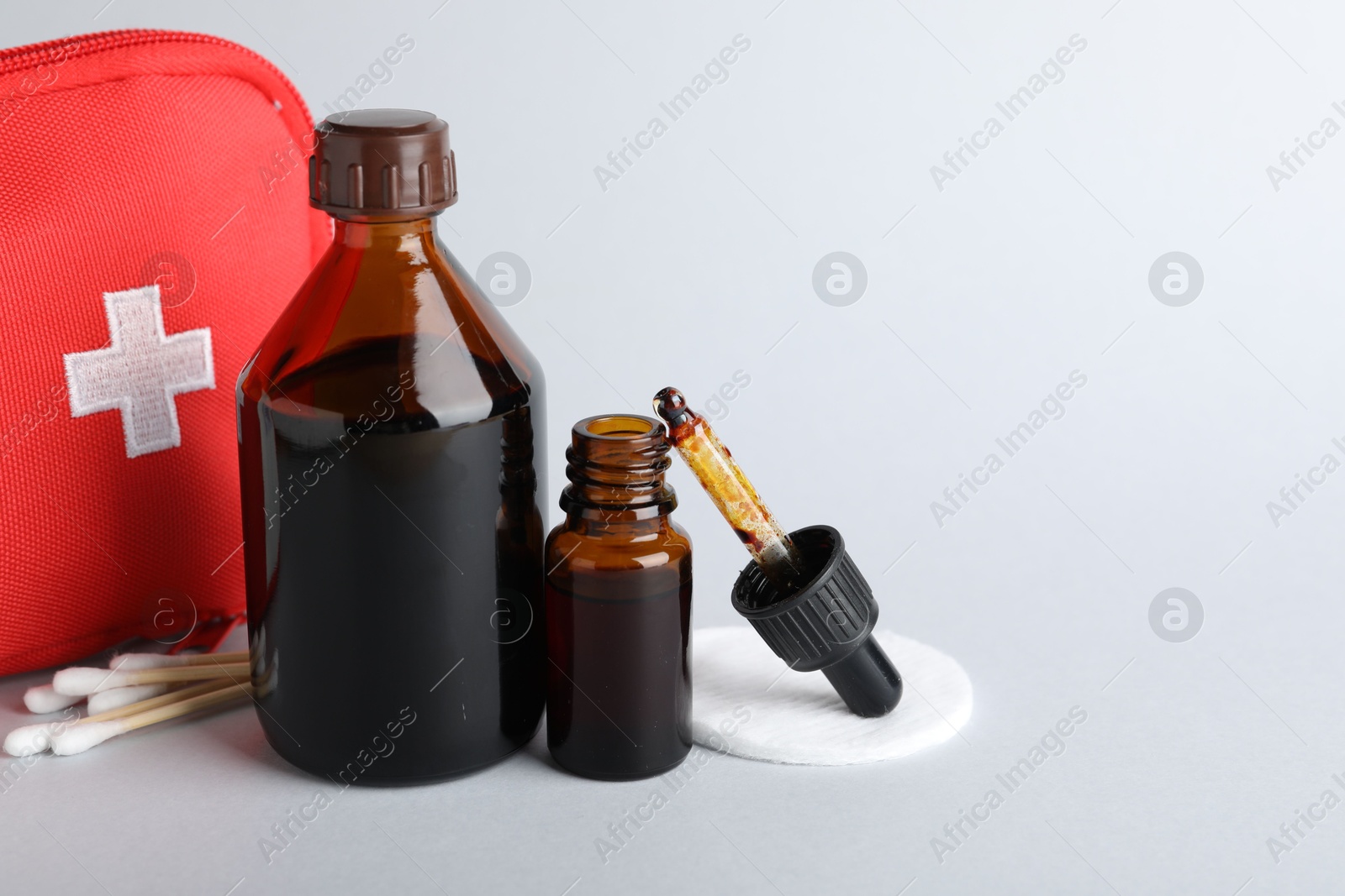 Photo of Topical iodine and other first aid kit components on light background. Space for text