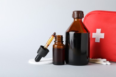 Photo of Topical iodine and other first aid kit components on light background. Space for text