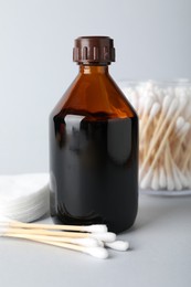 Photo of Topical iodine, cotton pads and swabs on light background