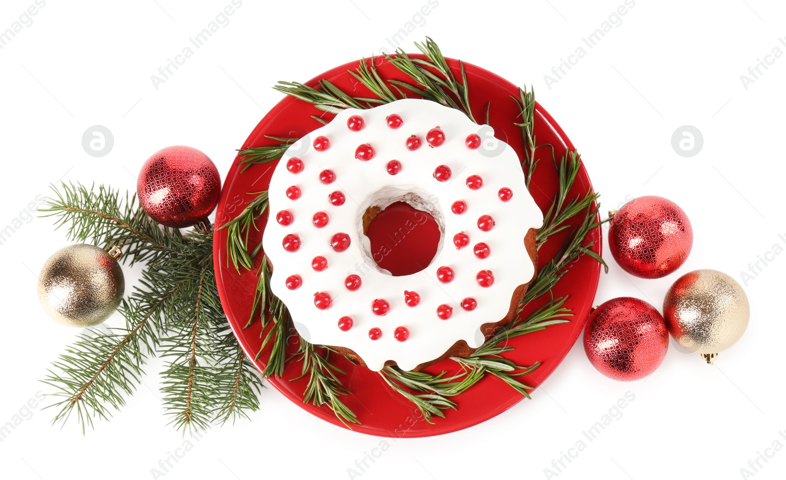 Photo of Tasty Christmas cake with red currants, rosemary, fir branches and baubles isolated on white, top view