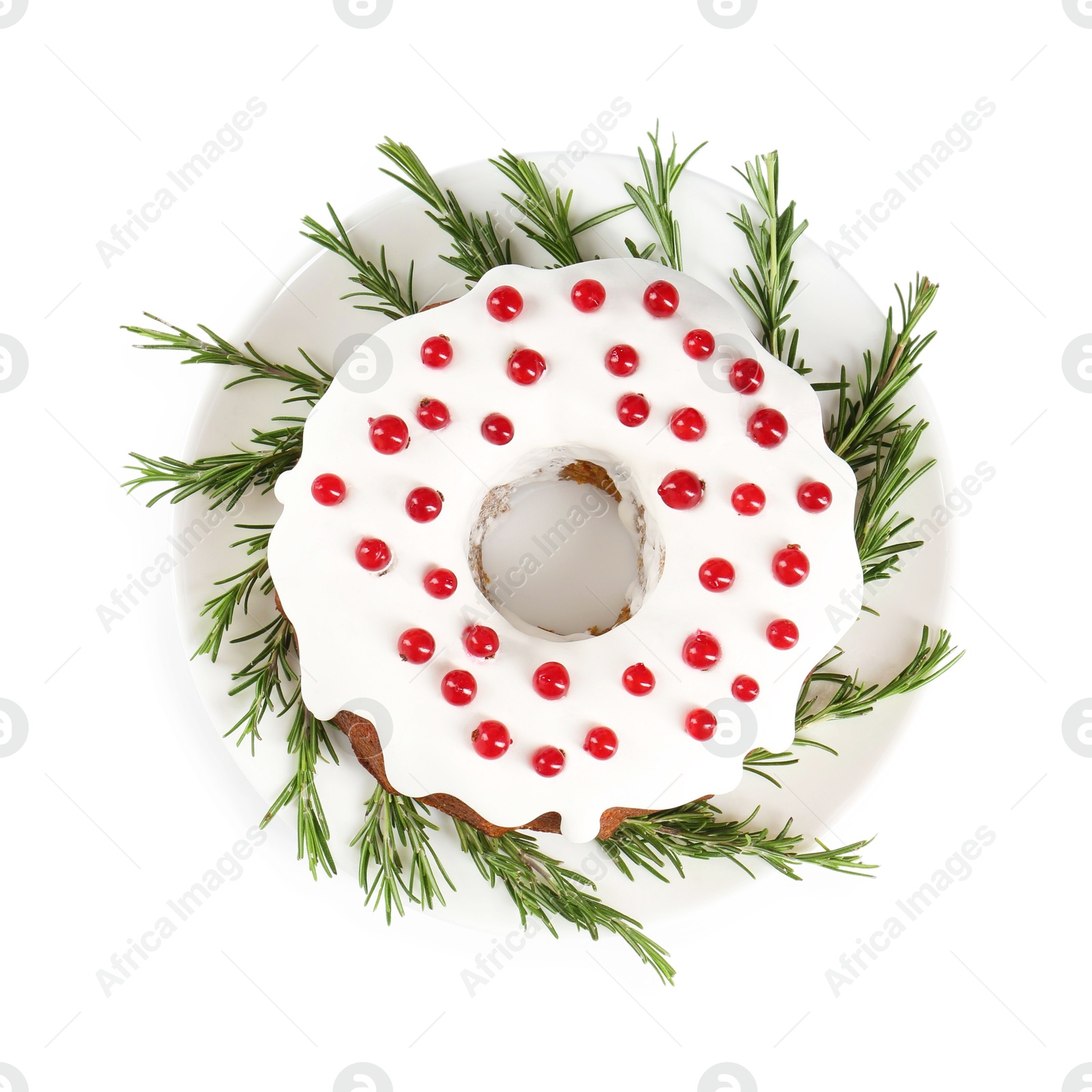 Photo of Traditional Christmas cake decorated with currants and rosemary isolated on white, top view