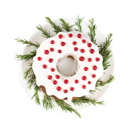 Photo of Traditional Christmas cake decorated with currants and rosemary isolated on white, top view