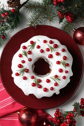 Photo of Traditional classic Christmas cake and decor on white table, flat lay