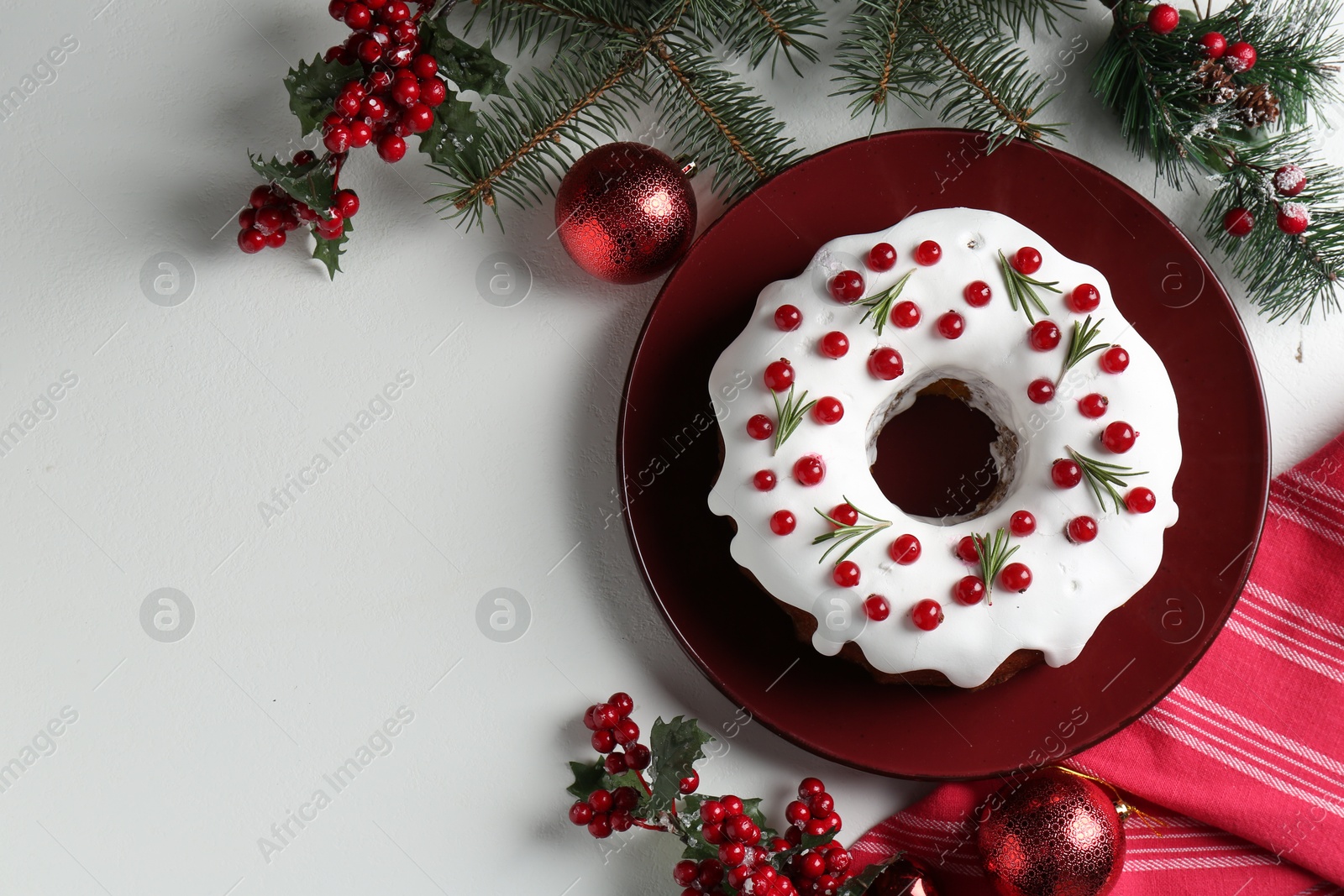 Photo of Traditional classic Christmas cake and decor on white table, flat lay. Space for text