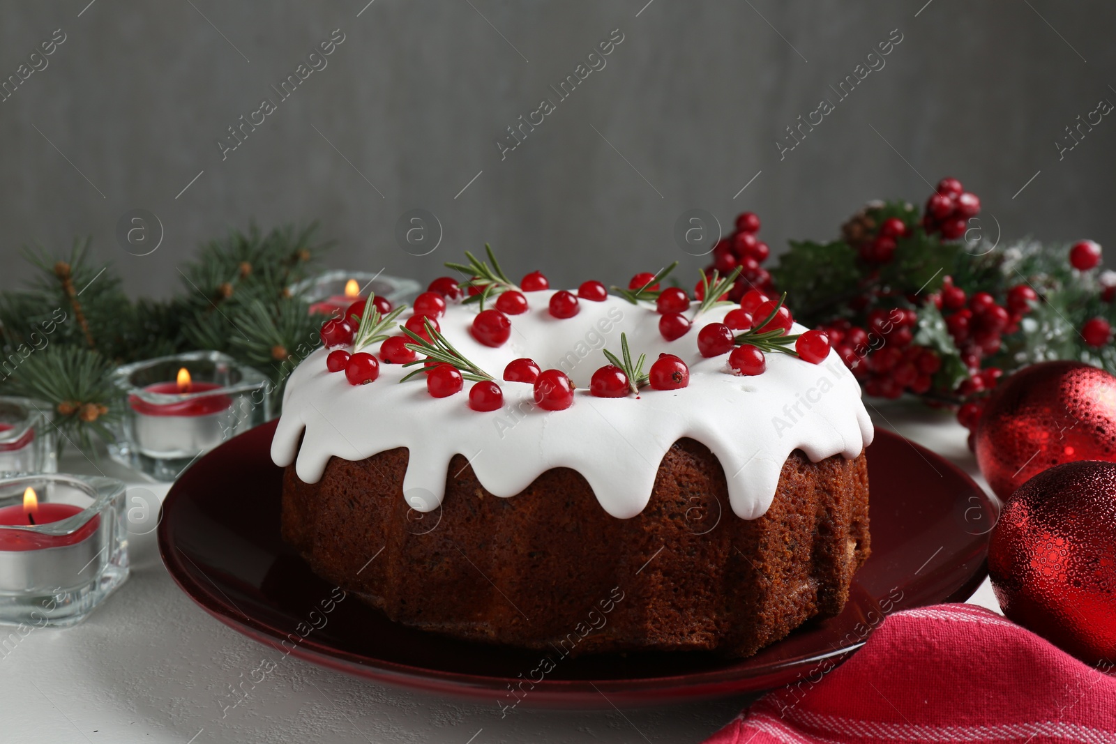 Photo of Traditional classic Christmas cake and decor on white table, closeup