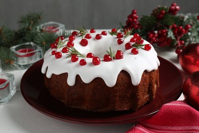 Photo of Traditional classic Christmas cake and decor on white table, closeup