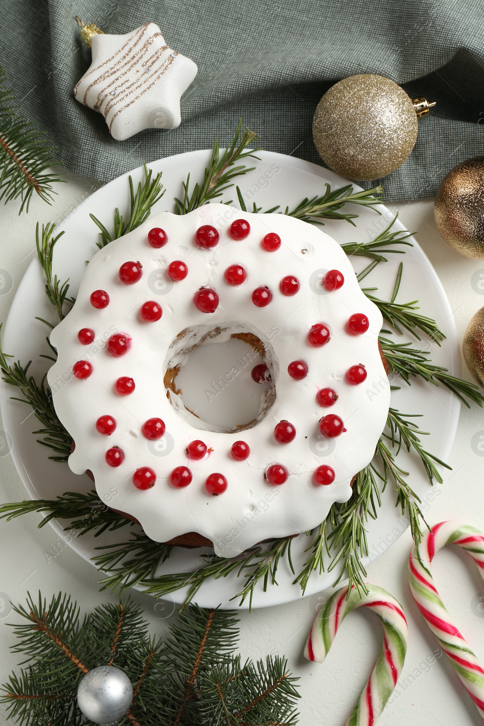 Photo of Traditional classic Christmas cake and decor on white table, flat lay