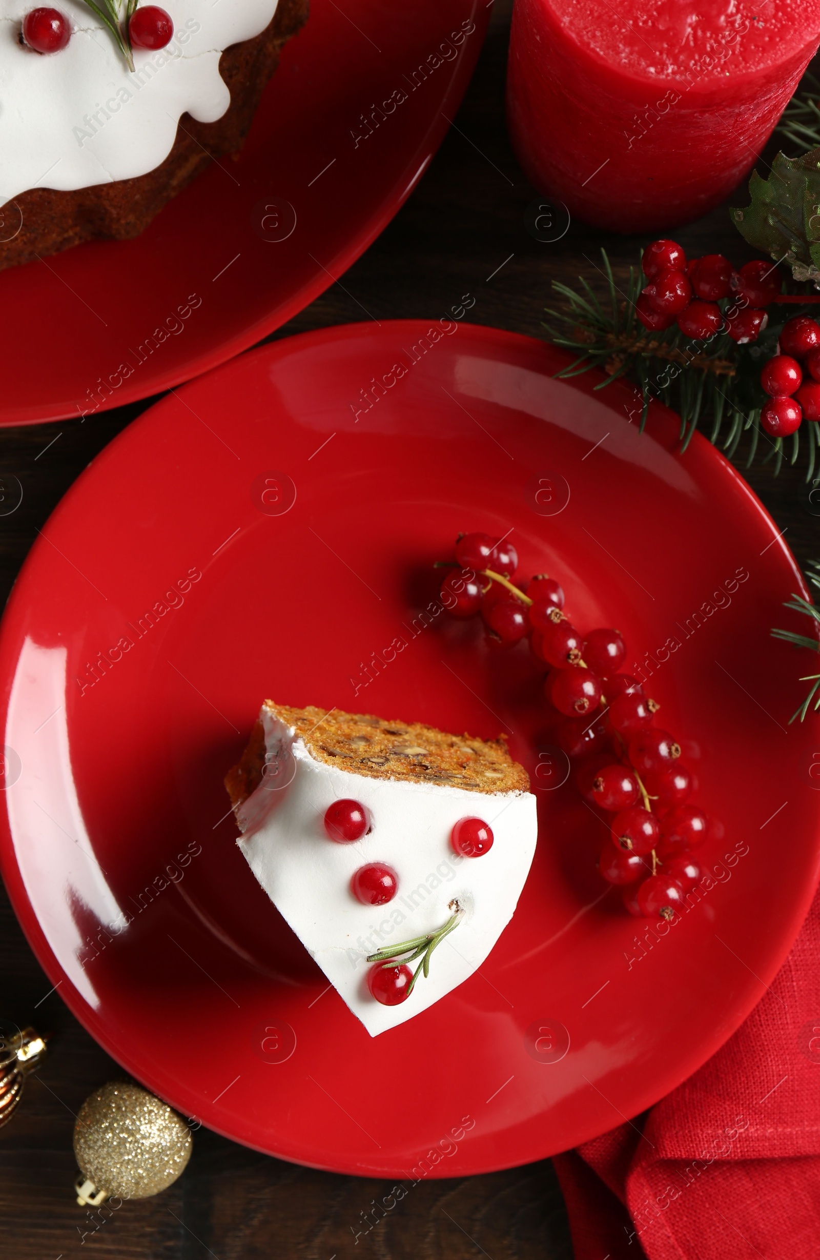 Photo of Pieces of traditional classic Christmas cake and decor on wooden table, flat lay