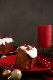 Photo of Piece of traditional classic Christmas cake and decor on table