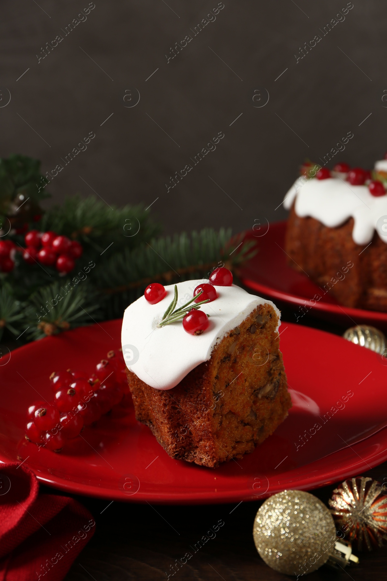 Photo of Piece of traditional classic Christmas cake and decor on wooden table