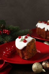 Photo of Piece of traditional classic Christmas cake and decor on wooden table