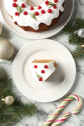 Photo of Traditional classic Christmas cake and decor on white marble table, flat lay