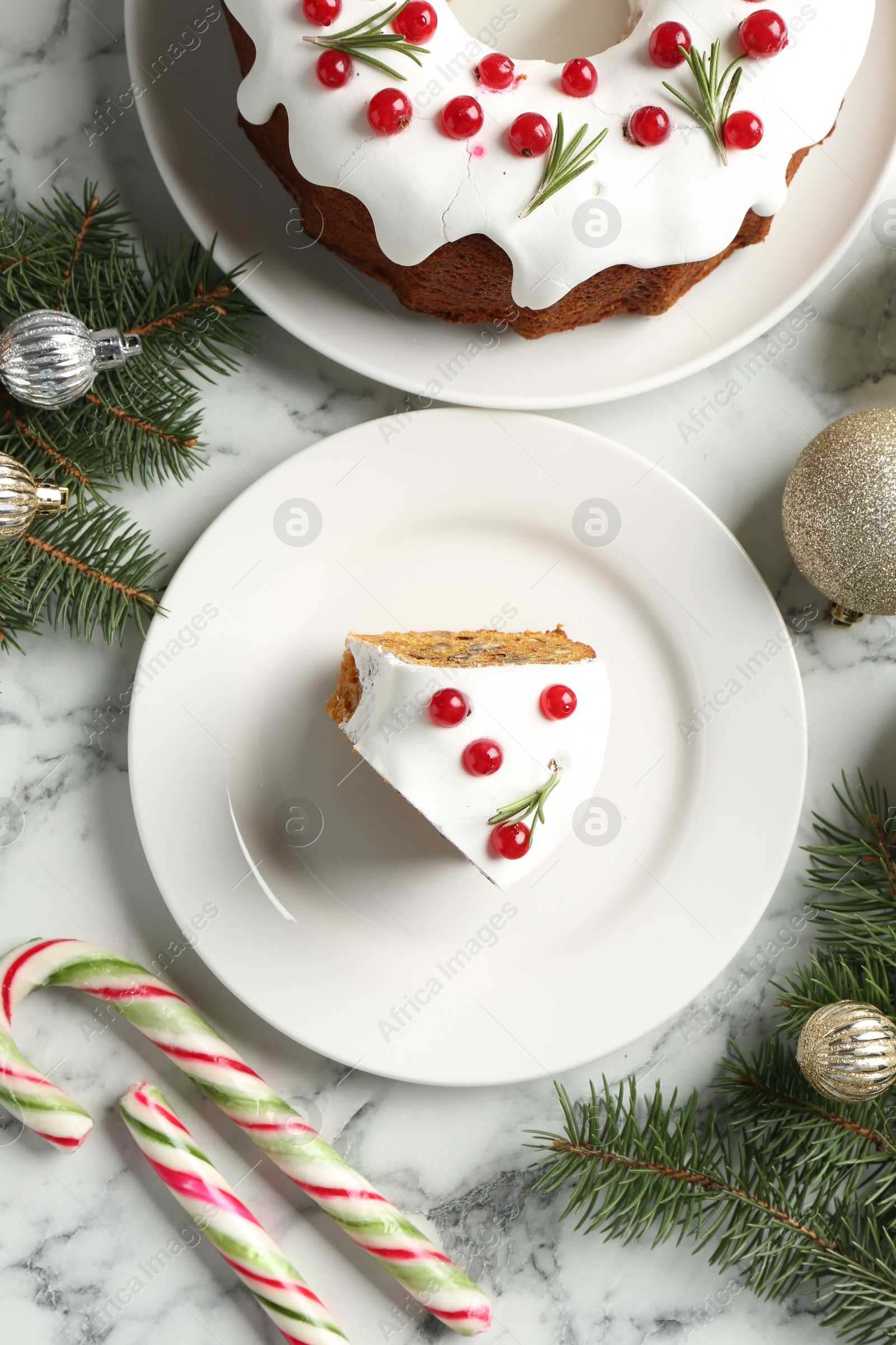 Photo of Traditional classic Christmas cake and decor on white marble table, flat lay