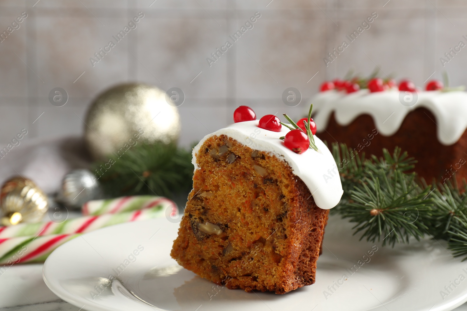 Photo of Piece of traditional classic Christmas cake and decor on table