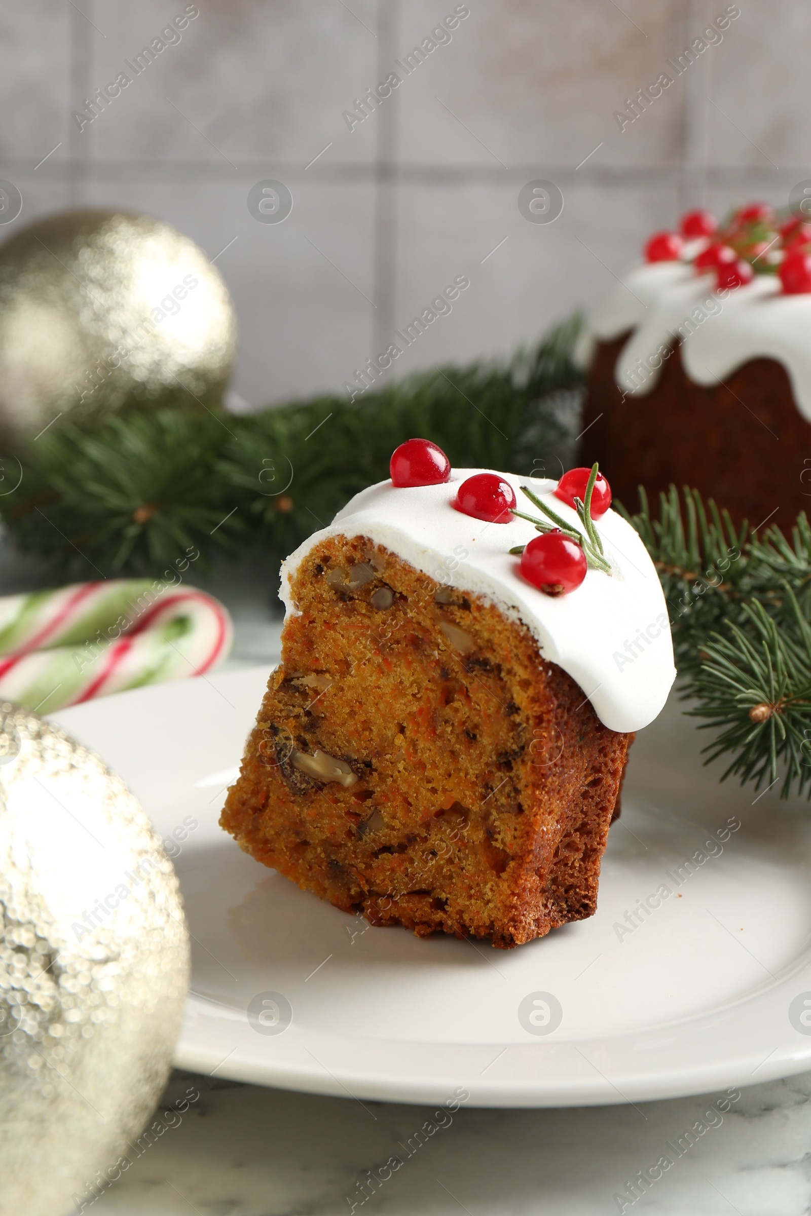 Photo of Traditional Christmas cake decorated with red currants and rosemary on light marble table