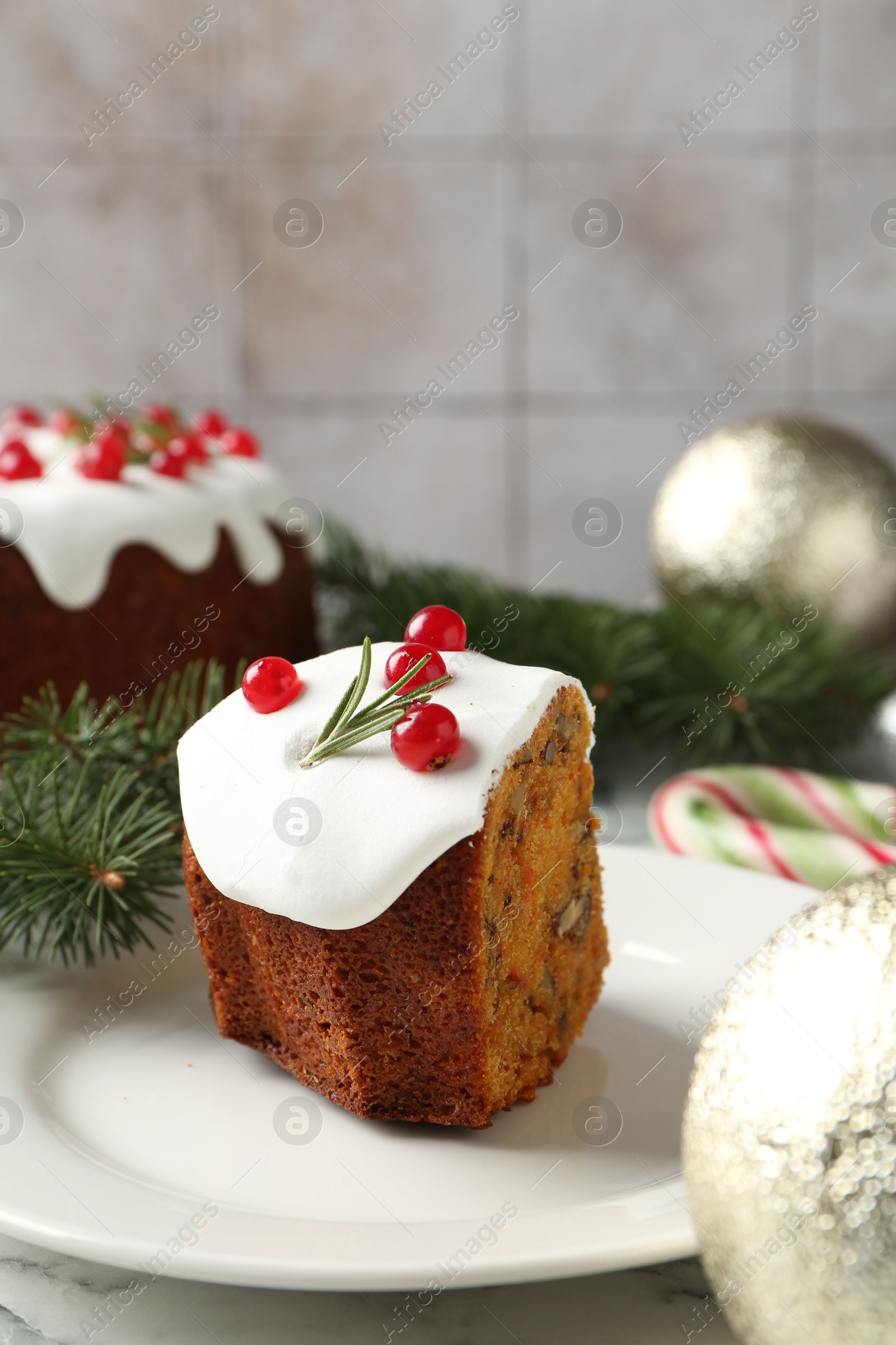 Photo of Traditional Christmas cake decorated with red currants and rosemary on table