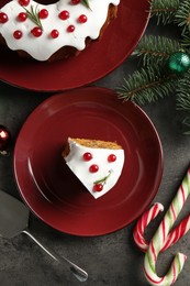 Photo of Traditional classic Christmas cake, decor and cake server on gray textured table, flat lay