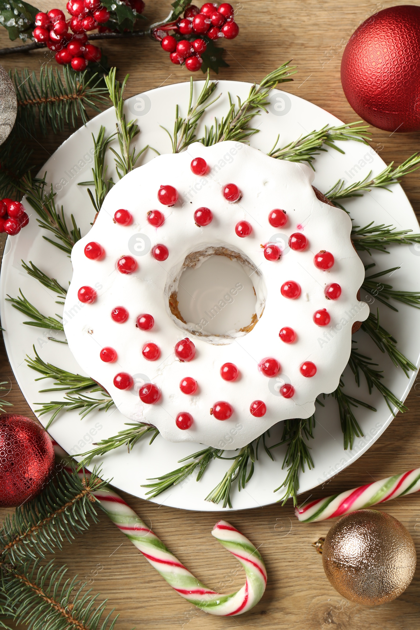 Photo of Traditional classic Christmas cake and decor on wooden table, flat lay