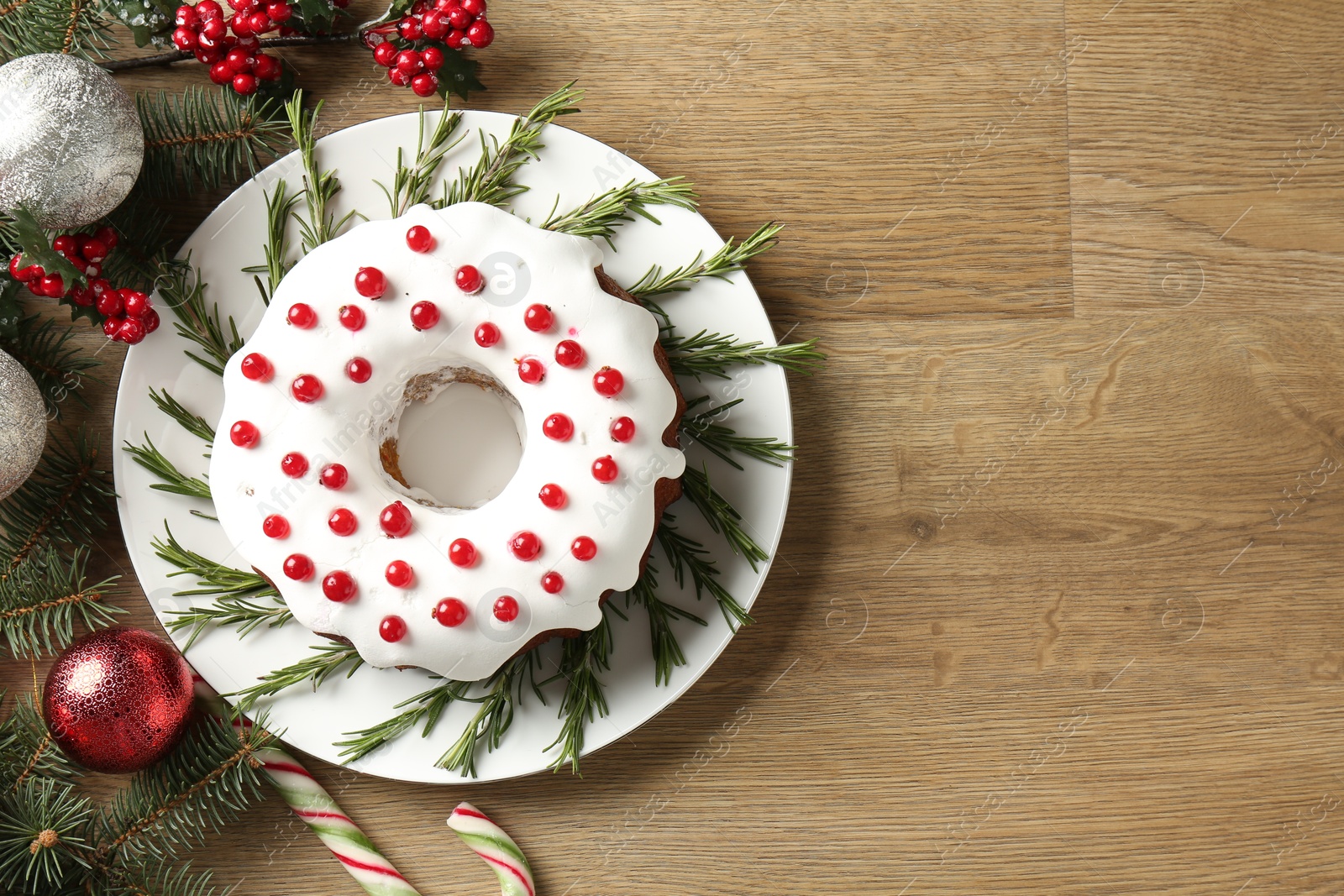 Photo of Traditional classic Christmas cake and decor on wooden table, flat lay. Space for text