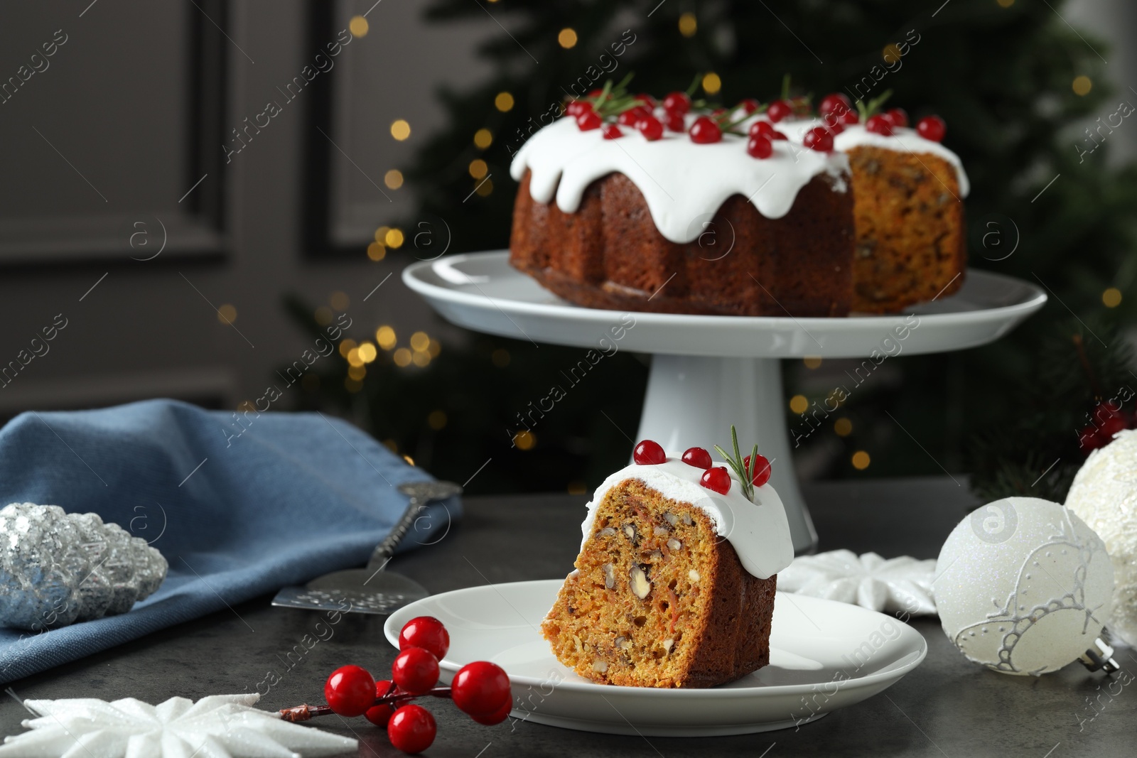 Photo of Traditional classic Christmas cake, decor and cake server on gray textured table