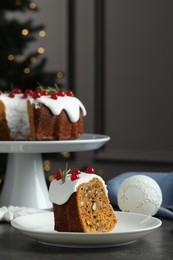 Traditional Christmas cake decorated with red currants and rosemary