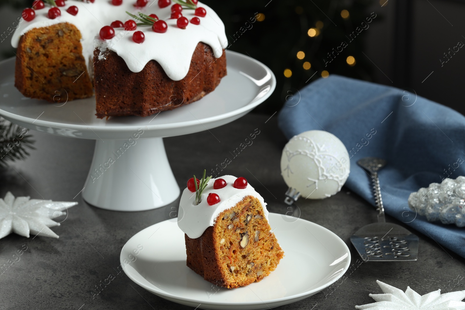 Photo of Traditional classic Christmas cake, decor and cake server on gray textured table