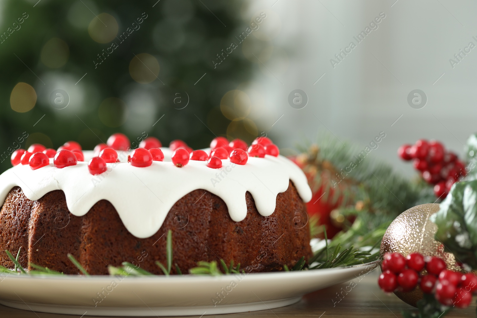 Photo of Traditional classic Christmas cake and decor on wooden table, closeup