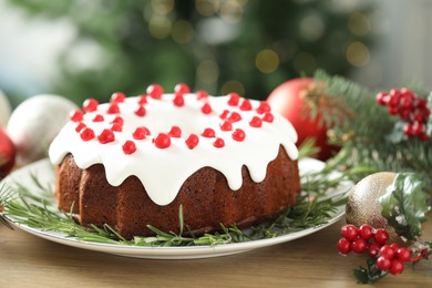 Photo of Traditional classic Christmas cake and decor on wooden table, closeup