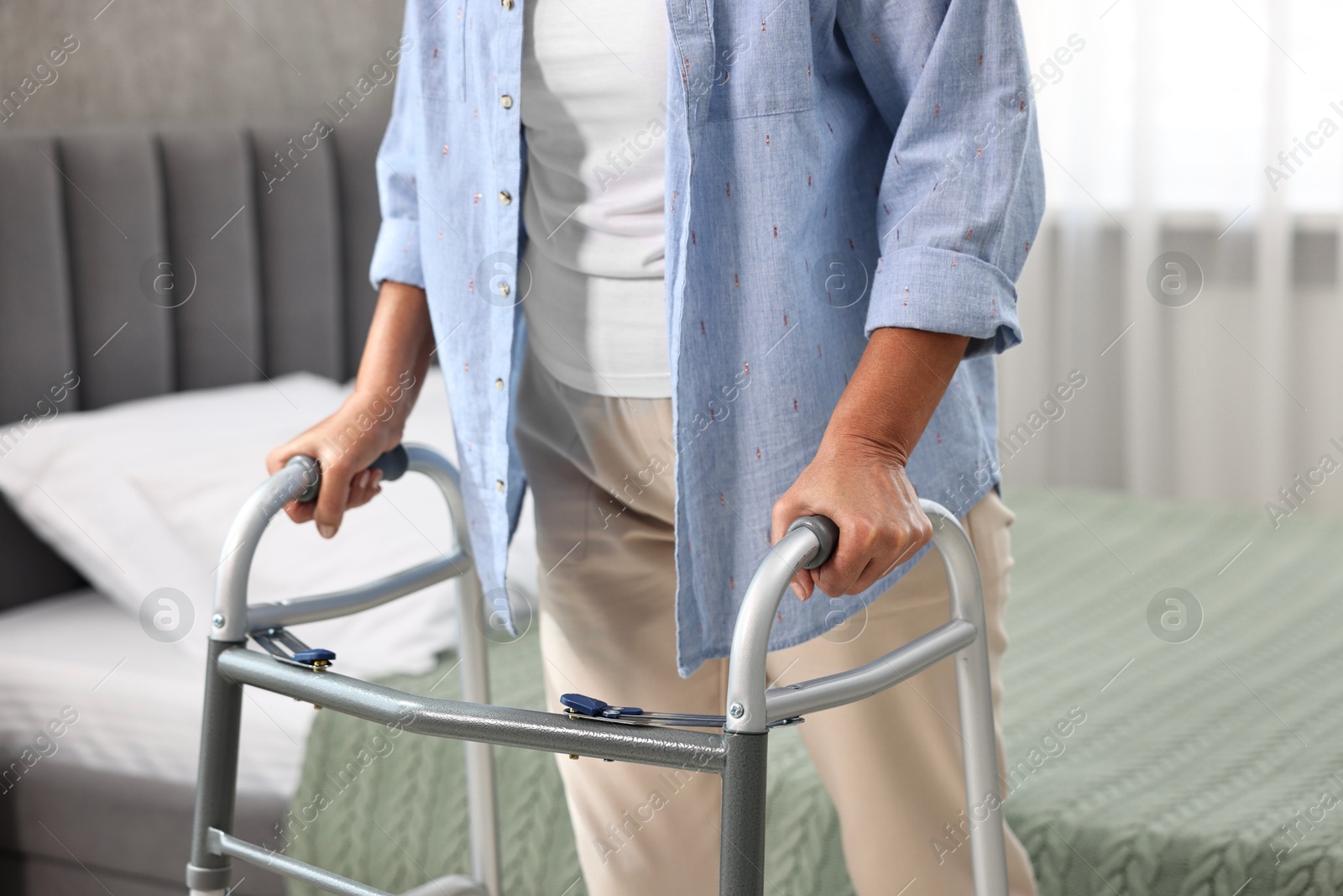 Photo of Senior woman with walking frame at home, closeup