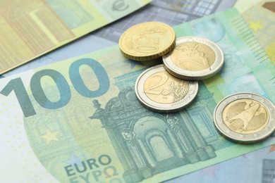 Photo of Different coins on euro banknotes, closeup view