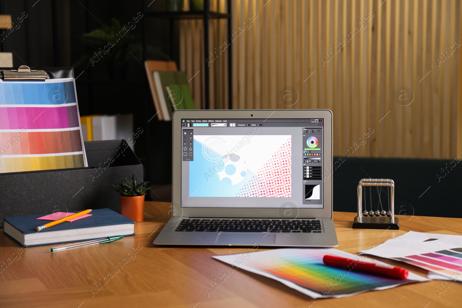 Photo of Designer's workplace with laptop, stationery and palettes on wooden table indoors