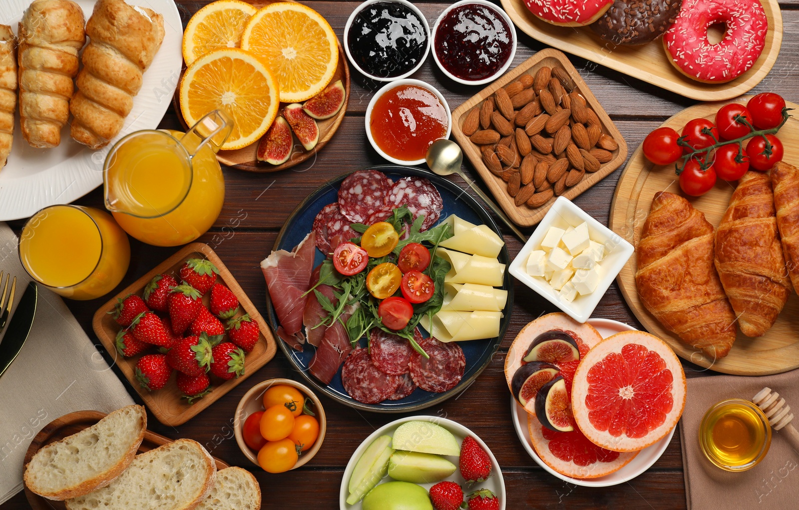 Photo of Different tasty food served for brunch on wooden table, flat lay