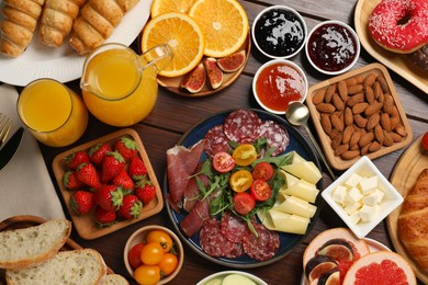 Photo of Different tasty food served for brunch on wooden table, flat lay