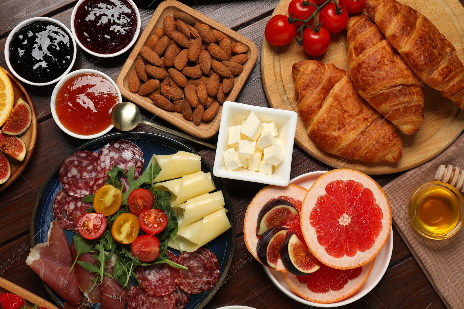 Photo of Different tasty food served for brunch on wooden table, flat lay