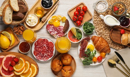 Photo of Different tasty food served for brunch on white wooden table, flat lay