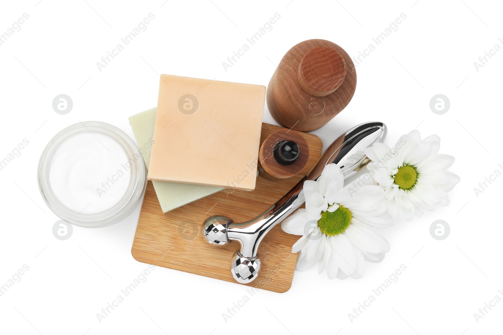 Photo of Face roller, cosmetic products and flowers isolated on white, top view