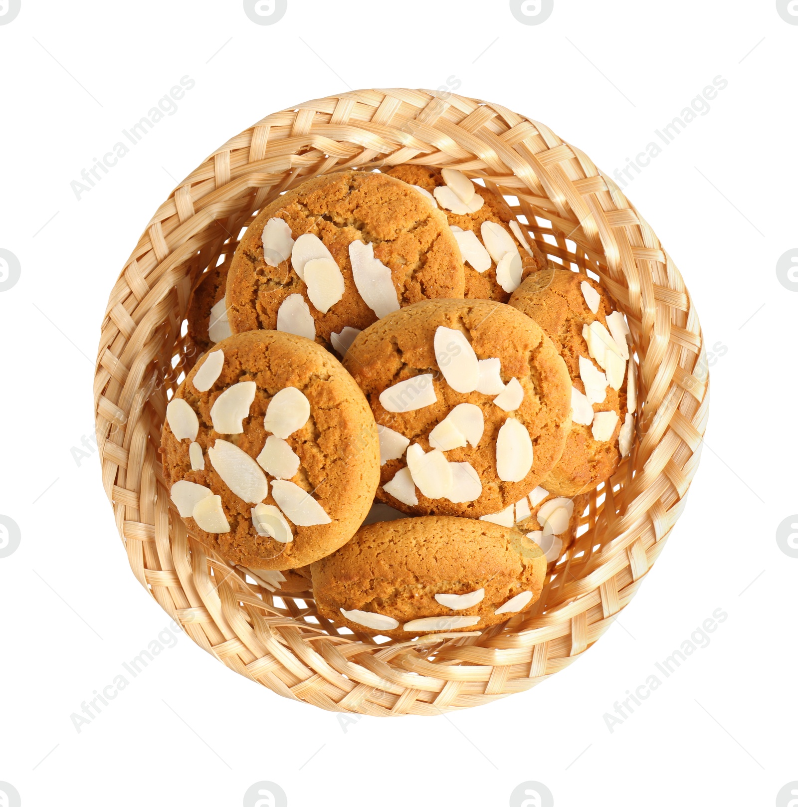 Photo of Tasty cookies with almond flakes in wicker basket isolated on white, top view